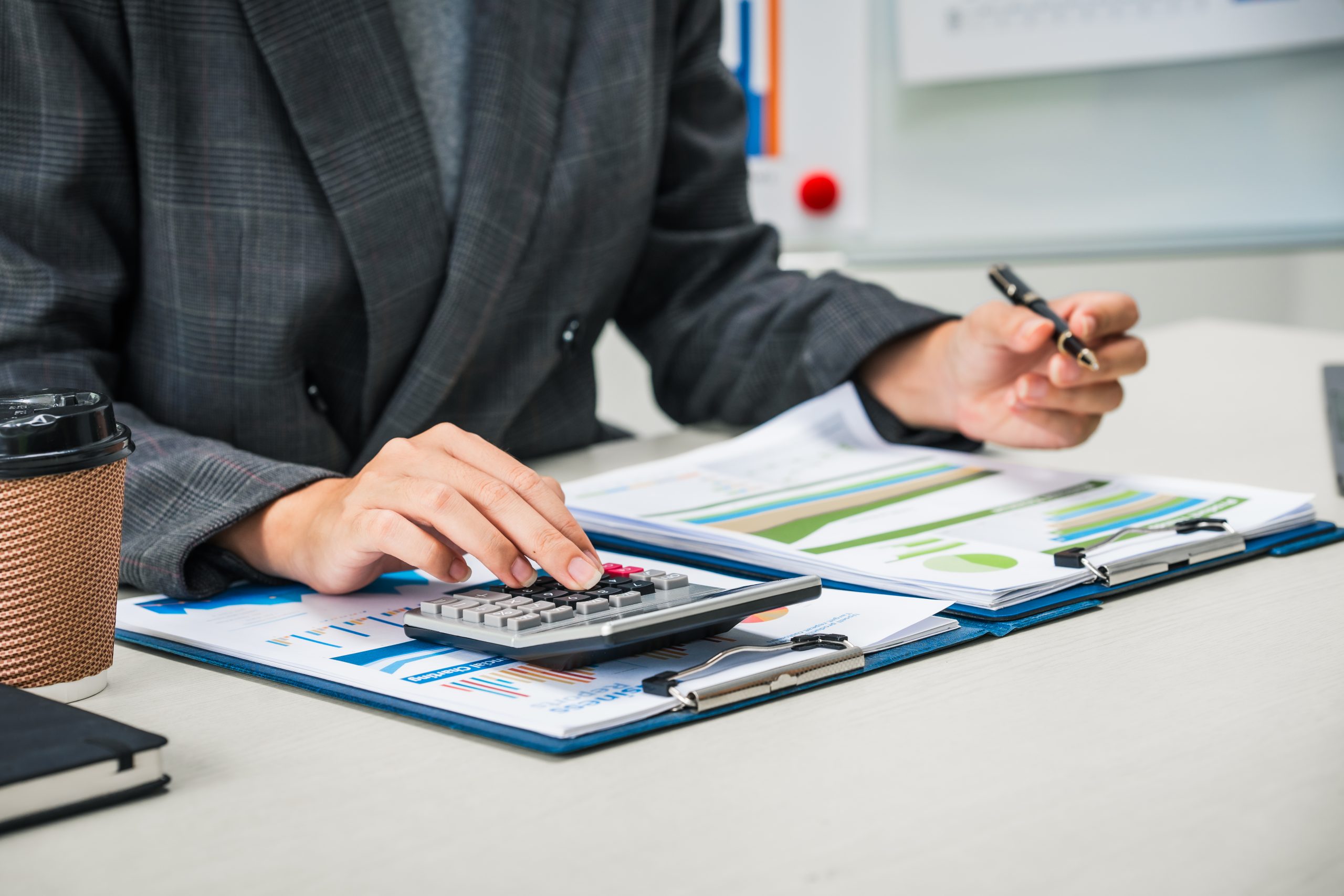 accountant works at desk, reviewing financial documents